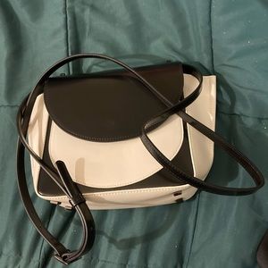 Forever elegant black and white Aquatalia designer handbag.